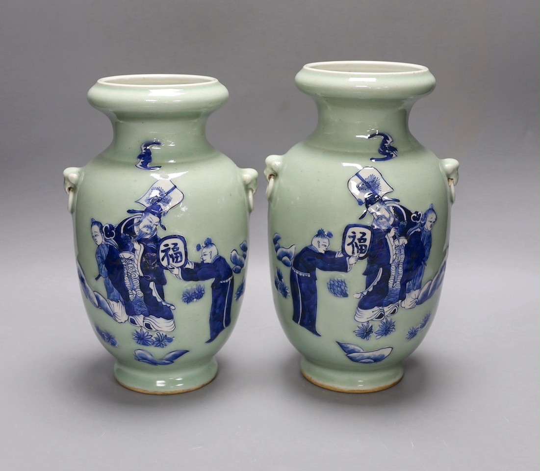 A pair of Chinese blue and white celadon ground vases, 26cms, painted with figures